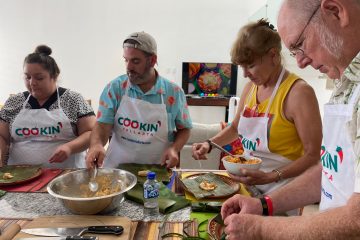 a group of people preparing food in a bowl